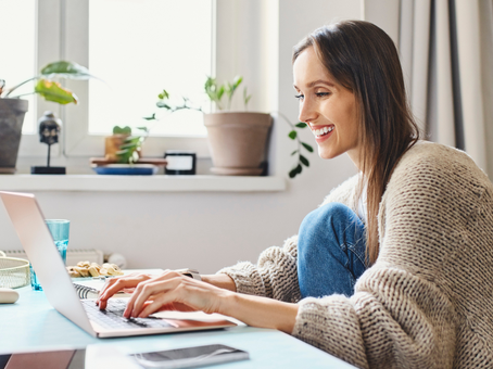 young adult typing on a laptop